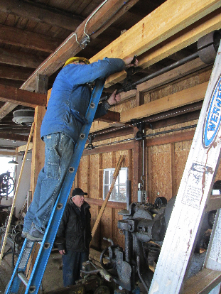 Volunteers installing line shafting